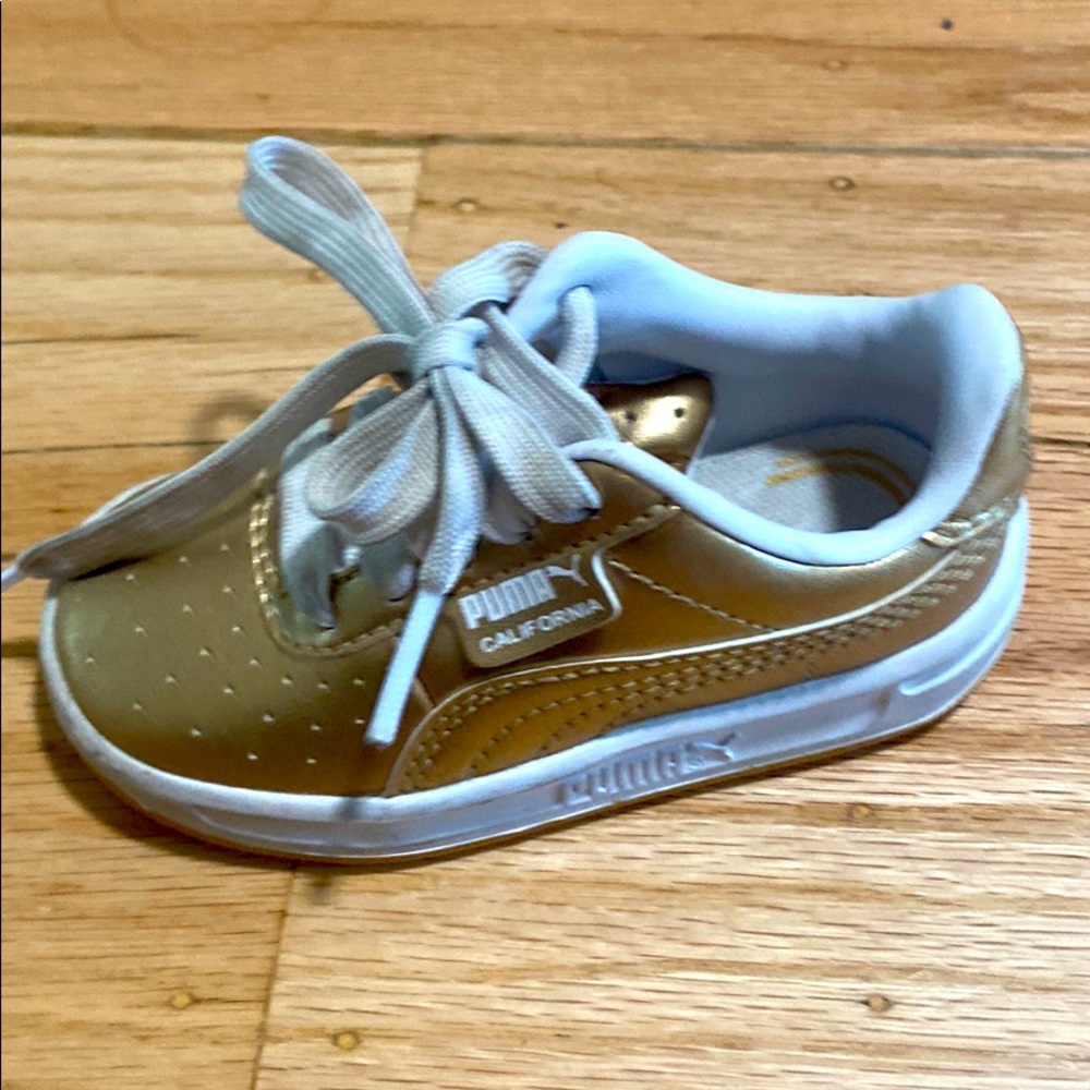 Gold puma shoes